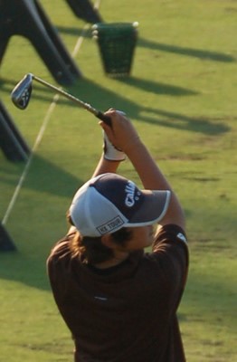 junior golfer taking a swing